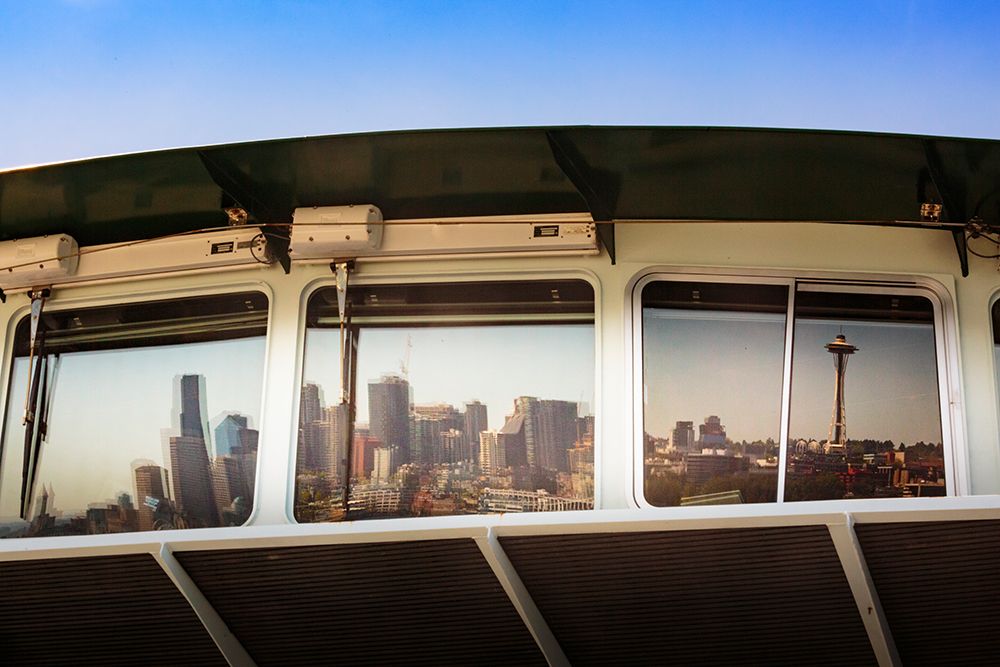 Reflection of Seattle skyline waterfront in ferry window, Washington State, USA.
